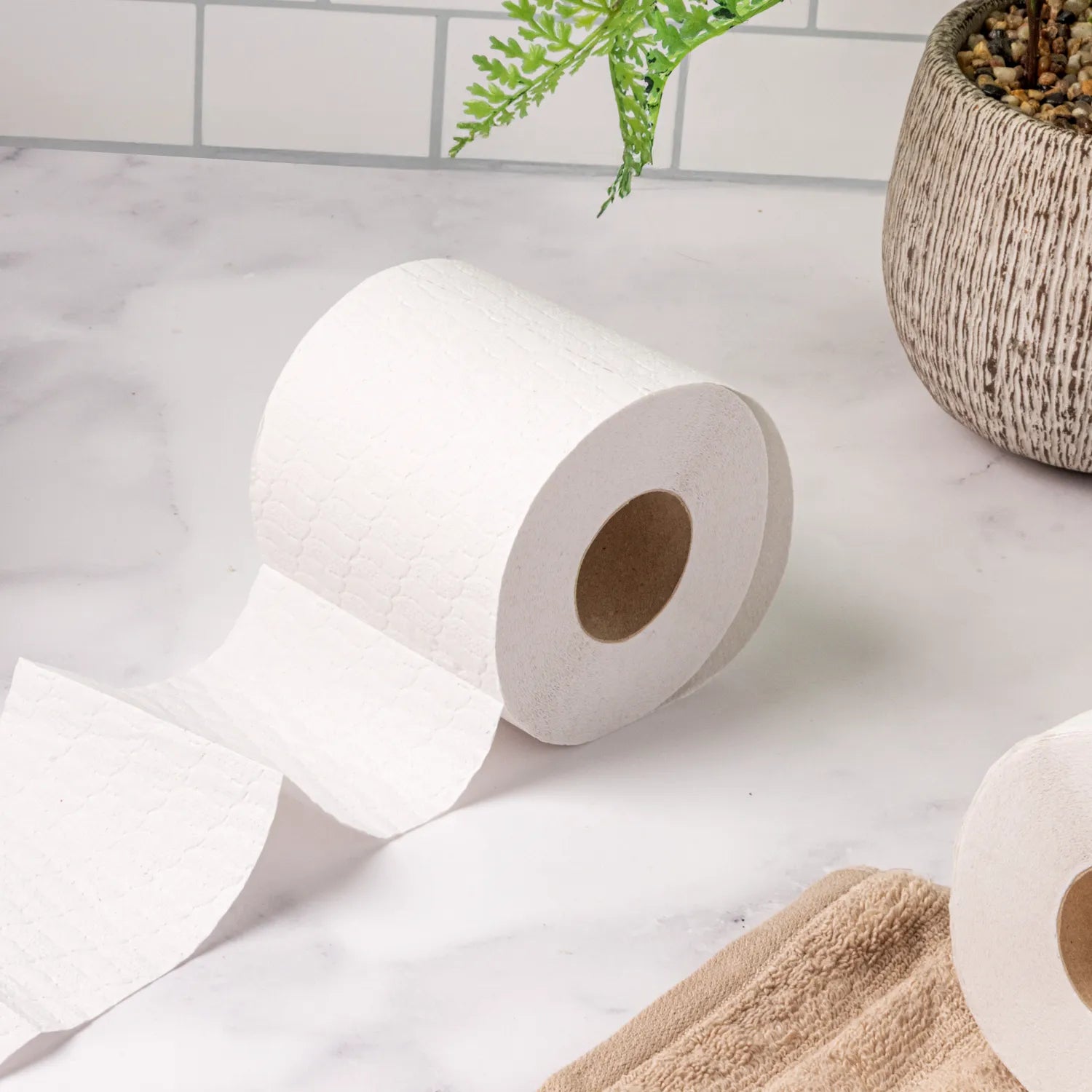 White toilet paper on a marble counter top